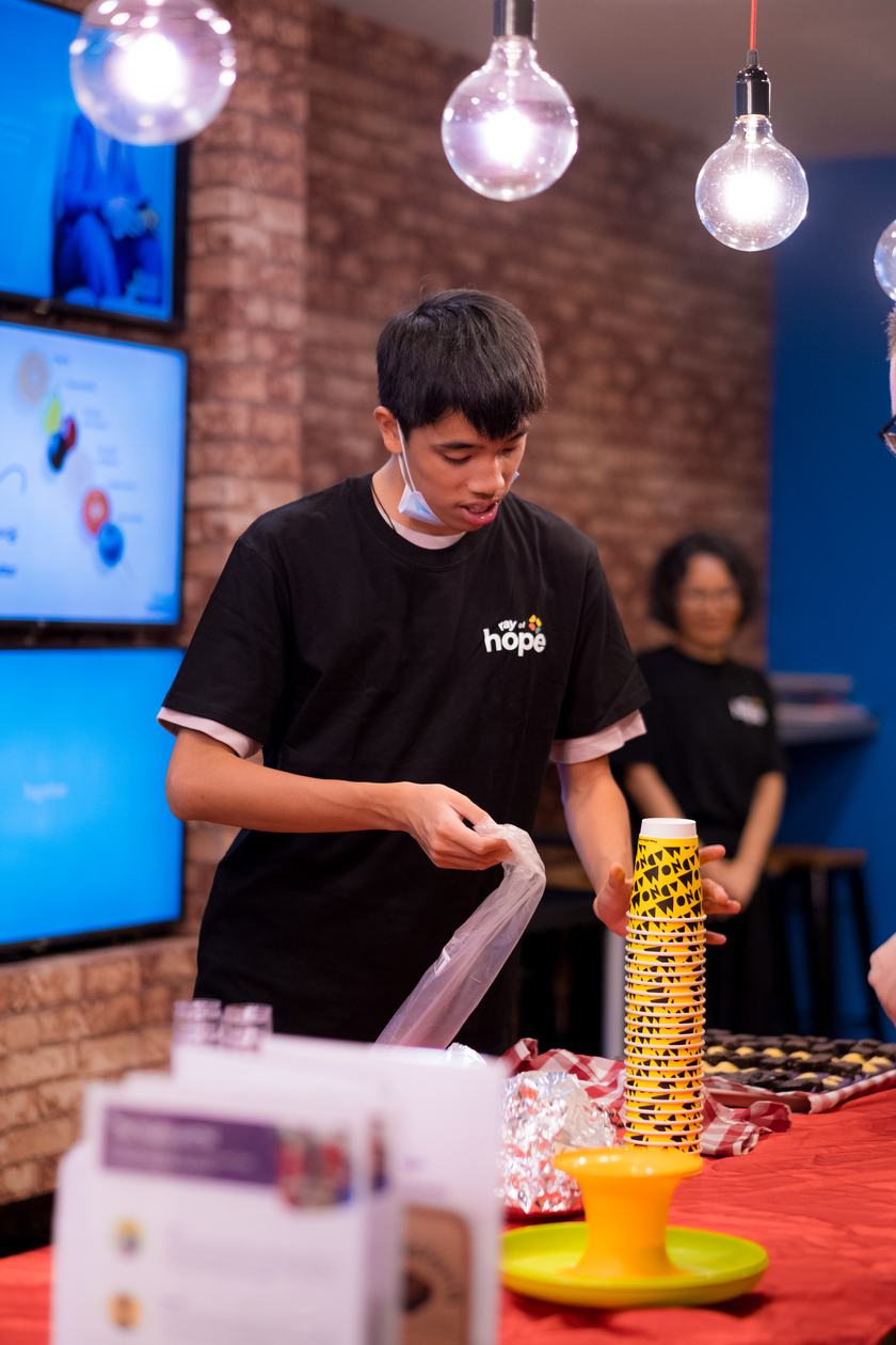 A youth setting up cups for a session